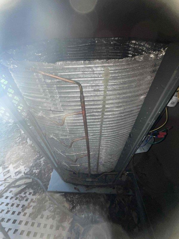 Completed comprehensive BFMA tune-up service on residential air conditioning system over 2 years old. Performed thorough inspection of evaporator coil assembly, condenser unit, and heat exchanger components, confirming proper fin alignment and adequate airflow through coil sections. Verified refrigerant lines and copper tubing connections are secure with no visible signs of leakage, checked condensate drain pan for proper drainage function, and documented system condition through photographic records showing clean coil surfaces with normal condensation present during operation.