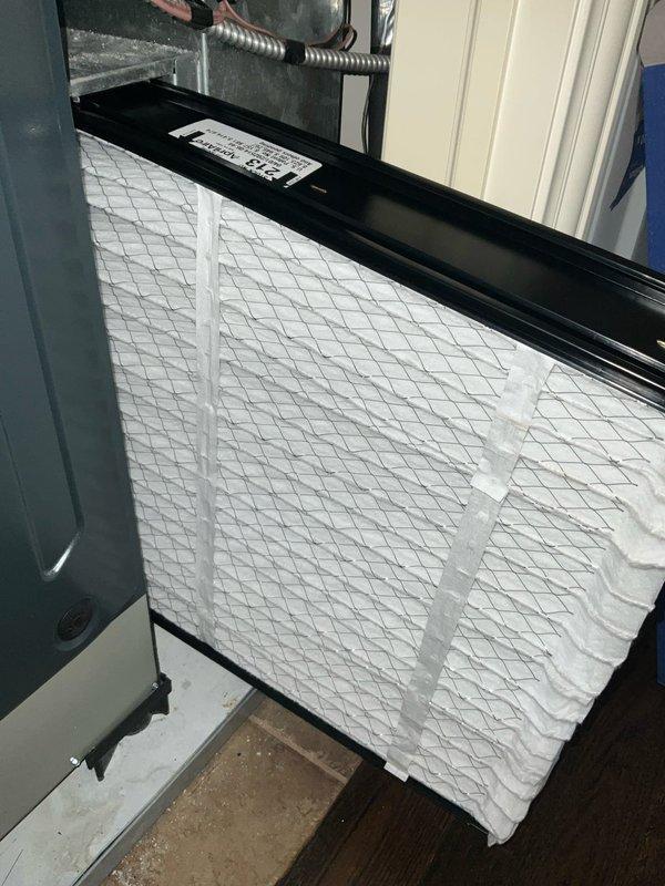 Completed comprehensive BFMA tune-up service on two outdoor air conditioning units, both over three years old. Performed standard maintenance procedures including system inspection, filter evaluation, and operational testing. Indoor air filter showed moderate dust accumulation and was assessed during interior unit inspection. Exterior units positioned against brick wall exhibited significant weathering, with the primary unit displaying advanced deterioration of top panel coating material, including peeling, cracking, and separation from metal casing. Both units operational following tune-up completion.