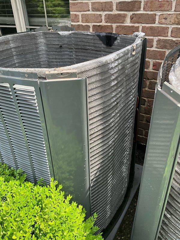 Completed comprehensive BFMA tune-up service on two outdoor air conditioning units, both over three years old. Performed standard maintenance procedures including system inspection, filter evaluation, and operational testing. Indoor air filter showed moderate dust accumulation and was assessed during interior unit inspection. Exterior units positioned against brick wall exhibited significant weathering, with the primary unit displaying advanced deterioration of top panel coating material, including peeling, cracking, and separation from metal casing. Both units operational following tune-up completion.