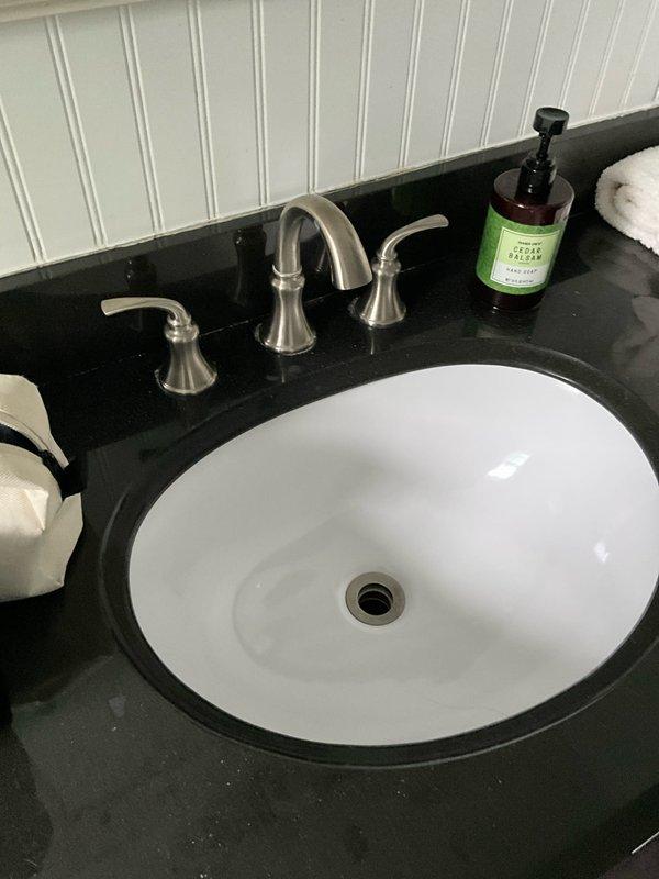 Completed comprehensive plumbing inspection as part of preventive maintenance tune-up service. Inspected basement plumbing systems including copper supply lines, pressure vessel assembly, shut-off valves, and pipe connections for proper operation and potential issues. Evaluated bathroom vanity plumbing including undermount sink, three-piece faucet assembly with brushed nickel finish, drain operation, and water supply connections. All plumbing components were found to be functioning properly with no leaks, corrosion, or immediate repair needs identified during the inspection.