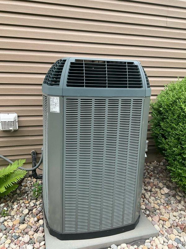 Completed comprehensive BFMA tune-up service on residential split system air conditioning unit aged 9+ years and tanked water heater. Performed full preventive maintenance on outdoor condenser unit including inspection of all major components, cleaning of coils, verification of refrigerant charge, testing of electrical connections, and assessment of overall system operation. Unit found to be in good operating condition with proper airflow clearance and professional installation on concrete pad with adequate drainage and landscaping clearance maintained.