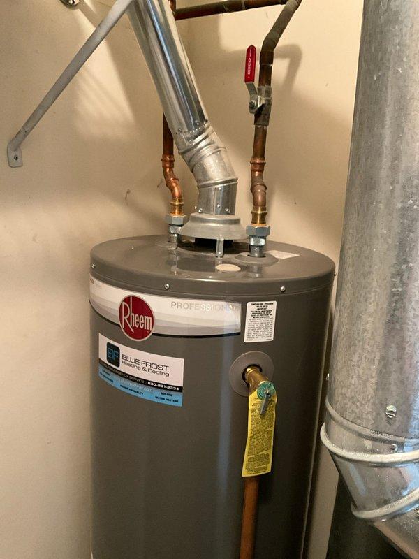 Responded to no hot water complaint at residential property. Upon arrival, inspected Rheem Professional Blue Frost tanked water heater and associated components. Evaluated gas control valve assembly, including brass fittings, pipe connections, and electrical conduit. Examined water heater plumbing connections at top of unit, including copper supply lines with brass fittings and red-handled ball valve on cold water inlet. Verified proper installation of galvanized vent pipe and all safety components. Diagnosed issue with gas control valve preventing proper heating function. Restored hot water service to residence. Unit tested and operating normally at time of departure.