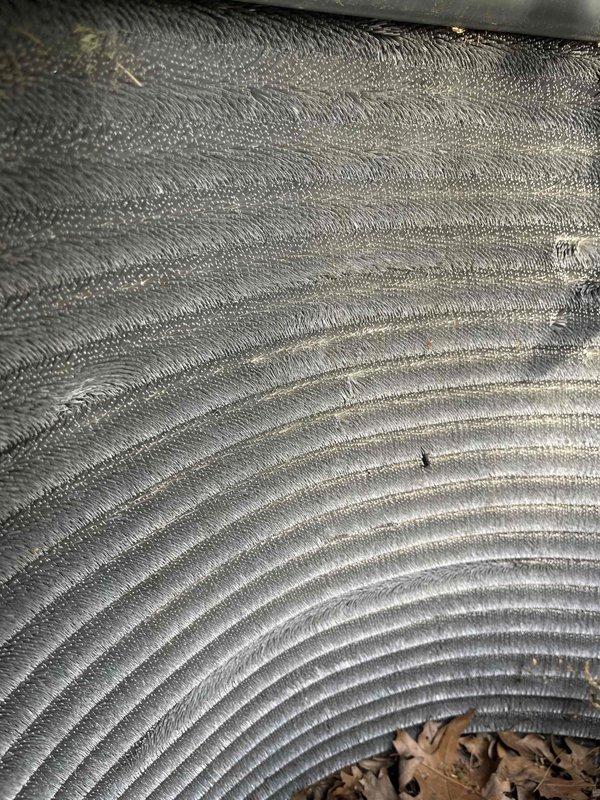 # HVAC Maintenance Summary

Completed comprehensive BFMA air conditioning tune-up on 5-year-old system. Performed standard preventive maintenance checklist including filter inspection, refrigerant level verification, electrical connection testing, condensate drain clearing, and thermostat calibration. Inspected flexible ductwork and discovered accumulated debris including leaves and organic material inside metal ducts, indicating potential air quality concerns or unsealed entry points. Documented ductwork condition with photos showing ribbed aluminum flex duct with debris accumulation at bottom sections.

# Detailed Work Performed

**System Inspection and Testing:**
- Conducted complete visual inspection of indoor and outdoor HVAC components
- Tested electrical connections and measured voltage/amperage at compressor and blower motor
- Verified proper refrigerant charge and system pressures
- Checked thermostat operation and accuracy
- Inspected condensate drain line for proper flow and