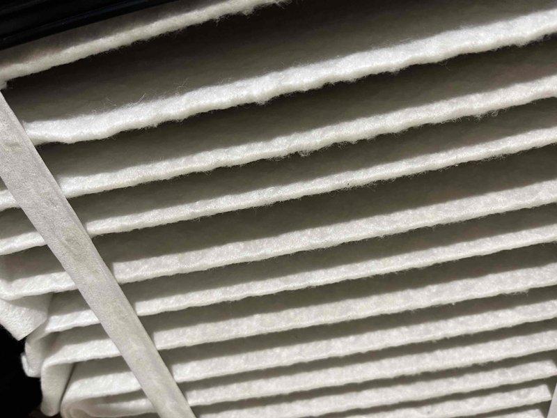 Completed comprehensive BFMA tune-up on residential air conditioning system. Upon inspection, discovered significant frost and ice accumulation on evaporator coils with heavy buildup obscuring aluminum fins, indicating potential airflow restriction or refrigerant issue. Documented condition of copper refrigerant lines showing normal oxidation patina, and noted dust and particulate matter accumulation on air filter and coil surfaces that required attention for optimal system performance.