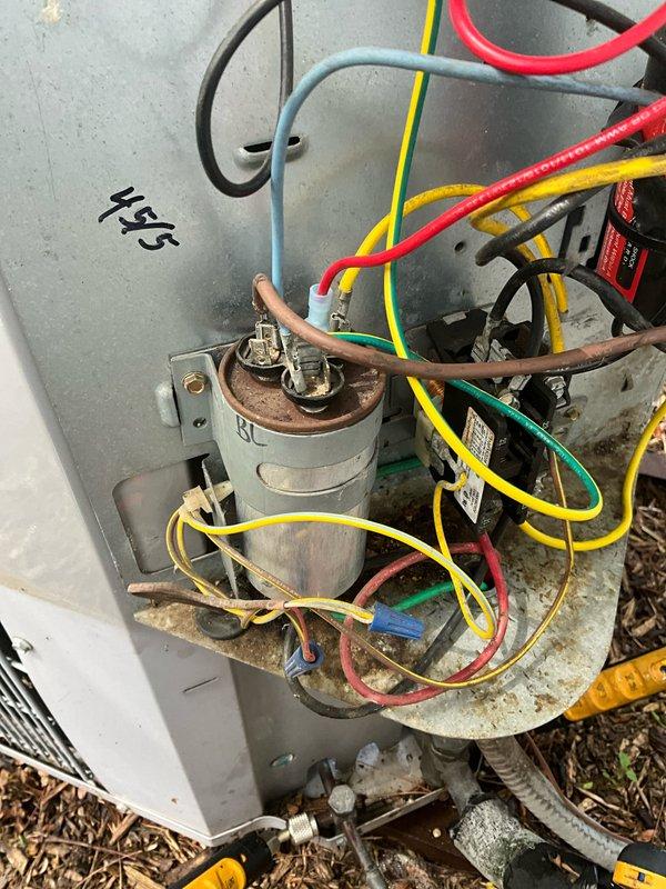 Completed comprehensive BFMA tune-up on 16+ year old outdoor AC unit. Inspected and tested capacitor showing signs of corrosion and rust, verified all electrical connections and wiring across terminal blocks, cleaned accumulated debris and organic matter from unit housing and mounting surfaces. System operational with all components functioning within normal parameters upon completion.