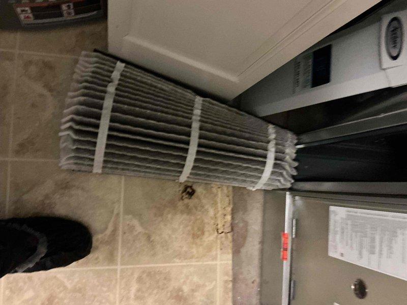 Completed comprehensive BFMA tune-up service on a 2-year-old air conditioning system. Performed standard preventive maintenance procedures on both indoor wall-mounted evaporator unit and outdoor rooftop condenser unit, including inspection of electrical components, disconnect boxes, and refrigerant lines. Noted heavy dust accumulation on indoor unit louvers and wall staining beneath evaporator, indicating potential condensate drainage issues requiring future attention.
