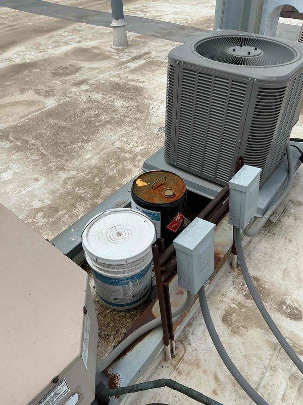 Completed comprehensive BFMA tune-up service on a 2-year-old air conditioning system. Performed standard preventive maintenance procedures on both indoor wall-mounted evaporator unit and outdoor rooftop condenser unit, including inspection of electrical components, disconnect boxes, and refrigerant lines. Noted heavy dust accumulation on indoor unit louvers and wall staining beneath evaporator, indicating potential condensate drainage issues requiring future attention.