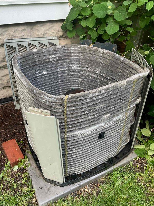 Completed comprehensive BFMA tune-up service on 9-year-old residential air conditioning system with cylindrical condenser coil configuration. Performed standard maintenance protocol including inspection of condenser unit, cleaning of coil fins showing visible dust and dirt accumulation, verification of electrical connections and components, and system operational testing. Unit photographed and confirmed in proper working condition upon completion of preventative maintenance service.