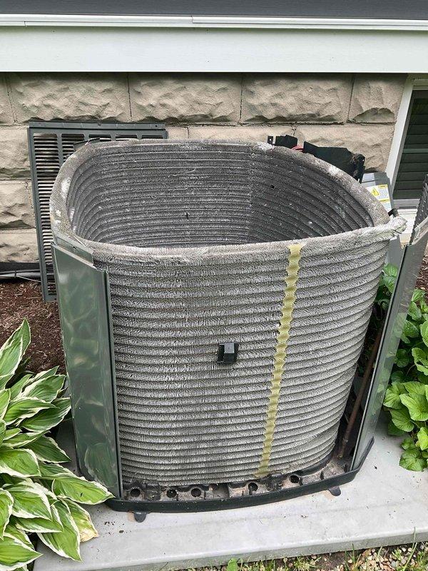 Completed comprehensive BFMA tune-up service on 9-year-old residential air conditioning system with cylindrical condenser coil configuration. Performed standard maintenance protocol including inspection of condenser unit, cleaning of coil fins showing visible dust and dirt accumulation, verification of electrical connections and components, and system operational testing. Unit photographed and confirmed in proper working condition upon completion of preventative maintenance service.