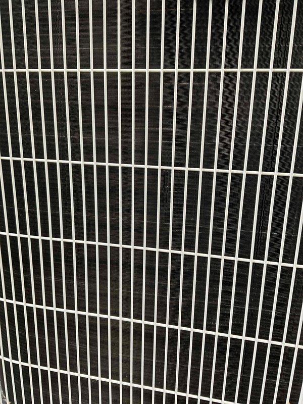 Responded to service call for Carrier outdoor condensing unit reported to have shifted off base with piping concerns. Upon arrival, performed visual inspection of unit and surrounding area. Condenser unit found positioned on ground mulch bed adjacent to structure with white vinyl siding. Inspected unit cage, coil fins, and refrigerant line connections for displacement, damage, or stress points. Protective grille and internal components examined for proper alignment and structural integrity. Unit appears stable with no visible damage to cabinet, coil assembly, or piping connections observed during inspection.