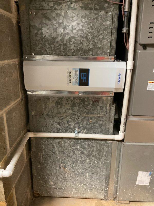 Upgraded existing air filtration system to Aprilaire 1210 media air cleaner with 20x25 filter configuration. Installed unit within existing ductwork system, mounted control panel on air handler, and verified proper operation with digital display showing active status at 87% filter life remaining.