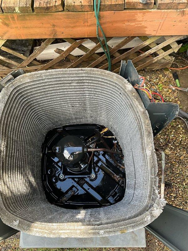 Completed comprehensive BFMA tune-up service on 8+ year old residential HVAC system, including full air conditioning unit maintenance and water heater inspection. Performed thorough inspection of outdoor condenser unit, noting accumulated dirt and debris on aluminum cooling fins and spiral ribbed coils. Cleaned coil surfaces, checked refrigerant levels, inspected fan blade assembly and motor housing, verified electrical connections at disconnect panel, and ensured proper system operation. Unit showed typical outdoor weathering but maintained functional integrity throughout testing procedures.