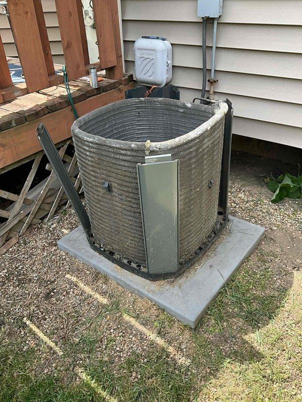Completed comprehensive BFMA tune-up service on 8+ year old residential HVAC system, including full air conditioning unit maintenance and water heater inspection. Performed thorough inspection of outdoor condenser unit, noting accumulated dirt and debris on aluminum cooling fins and spiral ribbed coils. Cleaned coil surfaces, checked refrigerant levels, inspected fan blade assembly and motor housing, verified electrical connections at disconnect panel, and ensured proper system operation. Unit showed typical outdoor weathering but maintained functional integrity throughout testing procedures.