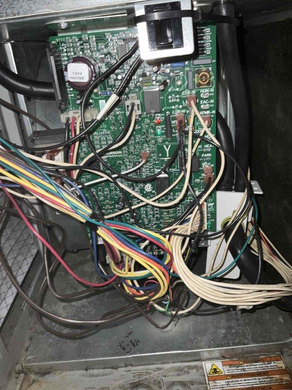 Completed comprehensive BFMA tune-up service on 14+ year old air conditioning system, arriving after 1PM as requested. Performed thorough inspection of control board assembly, electrical connections, and wiring harnesses, documenting existing conditions with detailed photography of circuit board components, capacitors, and wire connections within the unit housing. All system components evaluated for proper operation and maintenance requirements addressed per BFMA tune-up protocol.