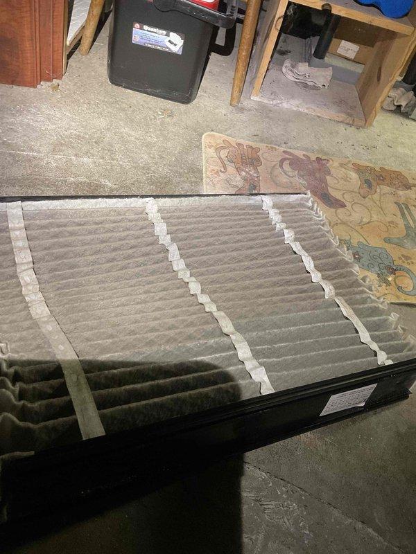 Completed comprehensive BFMA tune-up service on 12+ year old air conditioning system as first stop of the day. Performed standard AC maintenance protocol including system inspection, replaced disposable pleated air filter, and assessed evaporator coil condition. Upon inspection, discovered evaporator coils heavily contaminated with accumulated dust and debris buildup, significantly restricting airflow and reducing system efficiency. Noted copper refrigerant lines showing surface oxidation and greenish patina formation, indicating age-related deterioration. The dense layer of particulate matter coating the coil fins and accordion-style surfaces demonstrated extended operation without regular maintenance. White residue streaking observed on horizontal coil sections suggests possible condensate drainage issues or mineral deposits. The substantial contamination level found throughout the coil assembly will impair heat transfer capability and increase compressor workload if not addressed. D