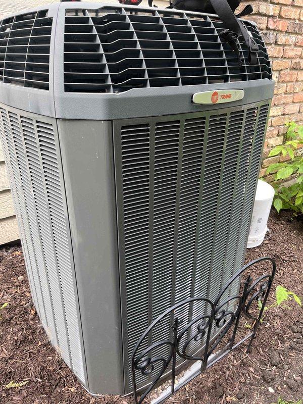 Completed comprehensive BFMA tune-up on 8+ year old Trane air conditioning system. Performed standard maintenance protocol including inspection of outdoor condensing unit, verification of refrigerant lines and evaporator coil condition, and system operational testing. Unit found in good overall condition with clean exterior housing and intact components positioned on proper concrete pad with adequate clearance from surrounding landscaping.
