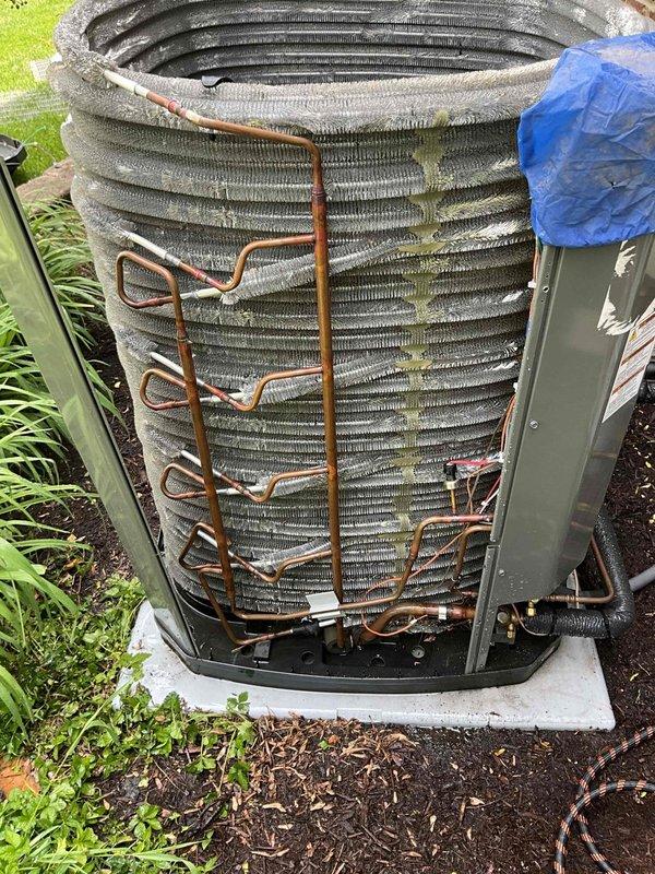 Completed comprehensive BFMA tune-up on residential air conditioning system per scheduled maintenance protocol. Removed exterior panels to access internal components and performed thorough inspection of condenser unit. Coil fins showed significant accumulation of dirt, debris, and outdoor contaminants affecting heat transfer efficiency. Cleaned evaporator coil assembly and aluminum fin surfaces to restore proper airflow and system performance. Inspected refrigerant lines, copper tubing connections, and compressor housing for proper operation. Verified electrical connections at base plate and assessed overall system condition. Unit returned to normal operation with improved efficiency following cleaning and maintenance procedures.