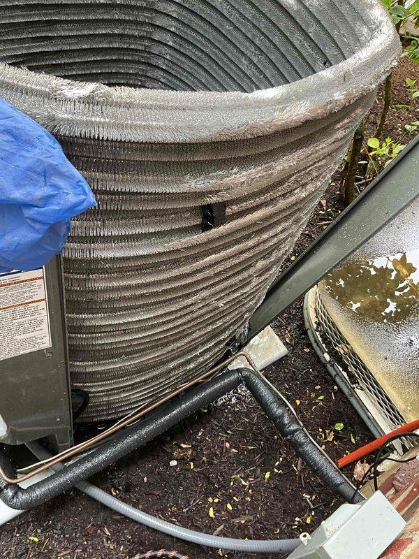 Completed comprehensive BFMA tune-up on residential air conditioning system per scheduled maintenance protocol. Removed exterior panels to access internal components and performed thorough inspection of condenser unit. Coil fins showed significant accumulation of dirt, debris, and outdoor contaminants affecting heat transfer efficiency. Cleaned evaporator coil assembly and aluminum fin surfaces to restore proper airflow and system performance. Inspected refrigerant lines, copper tubing connections, and compressor housing for proper operation. Verified electrical connections at base plate and assessed overall system condition. Unit returned to normal operation with improved efficiency following cleaning and maintenance procedures.