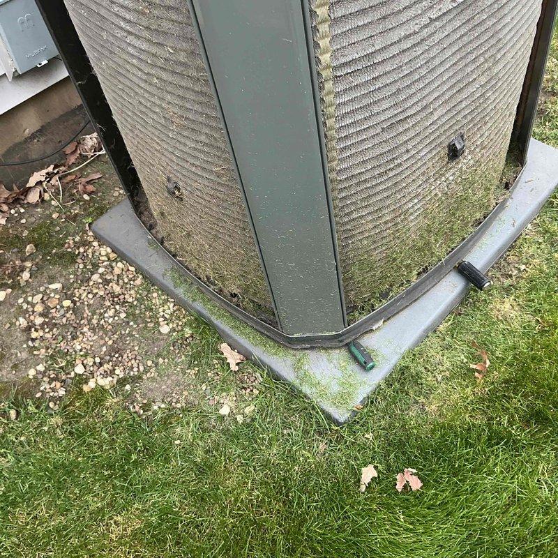 Completed comprehensive BFMA tune-up on residential air conditioning system with 7-year-old outdoor condensing unit. Unit exterior showed significant accumulation of dirt, debris, and biological growth on condenser coils and protective grilles, which was cleaned to restore proper airflow and heat transfer efficiency. Performed full preventive maintenance inspection including refrigerant line assessment, electrical connections verification, and clearing of organic debris from unit base and surrounding area to ensure optimal system performance.