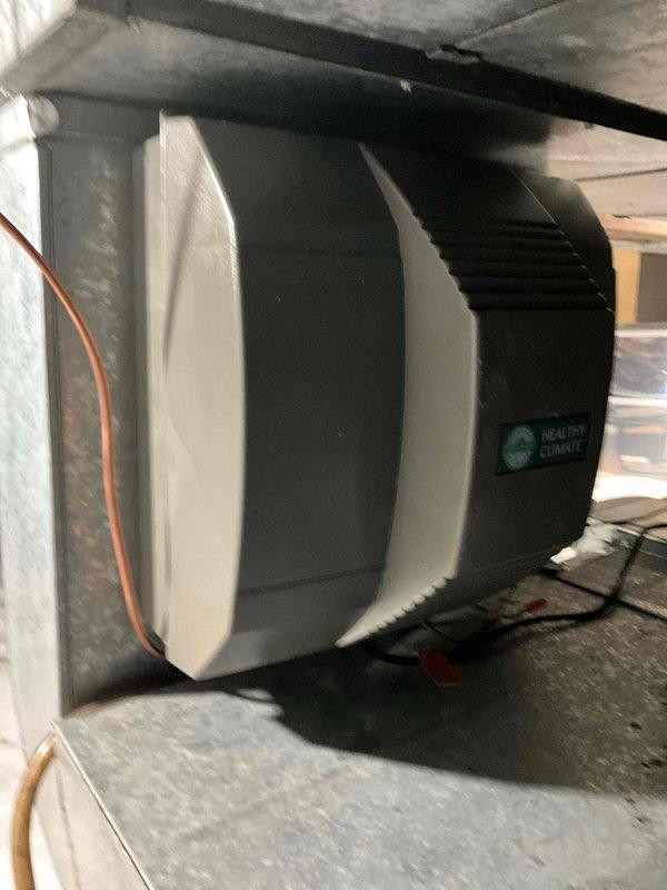 Completed installation of HCWP3 whole-home humidifier unit to existing HVAC system. Replaced broken door clips on Lennox furnace cabinet where mounting tabs had failed, ensuring proper access panel security and system integrity.