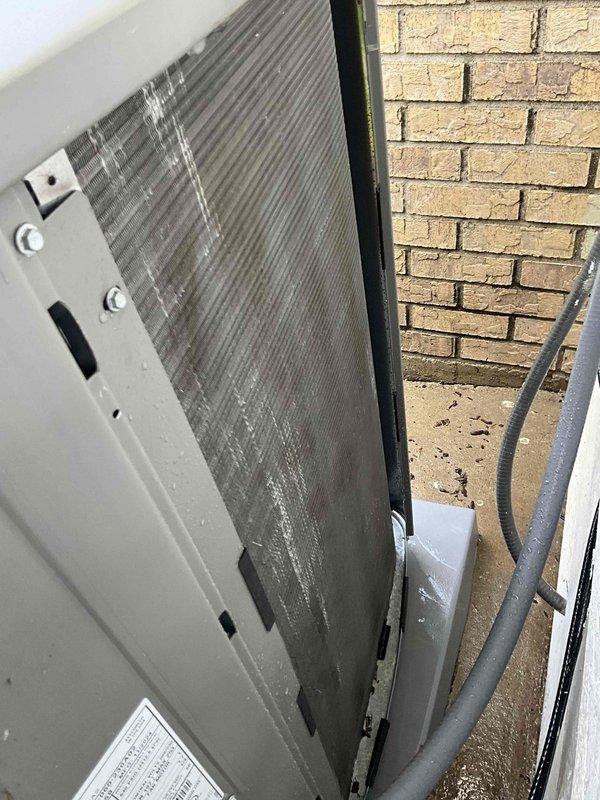 Completed comprehensive BFMA tune-up service on residential split-system air conditioning unit. Performed thorough inspection of outdoor condensing unit, including examination of condenser coil which showed dust and dirt accumulation between fins. Conducted standard AC maintenance procedures, replaced air filter as part of semi-annual filter change program, and verified all system components were operating within normal parameters. Unit access panels were opened to inspect internal components including finned heat exchanger coil, electrical connections, and mounting hardware. All work completed on 1-year-old equipment, with unit secured and returned to proper operating condition upon service completion.