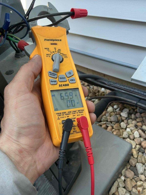 Completed comprehensive tune-up service on dual HVAC condenser units at residential property. Performed standard maintenance protocol including inspection of both systems, electrical testing of capacitors using digital multimeter to verify proper microfarad readings, checked refrigerant levels, cleaned condenser coils, and inspected all electrical connections and components. Both units were found to be in good operating condition with all readings within manufacturer specifications, ensuring optimal system performance for the cooling season.
