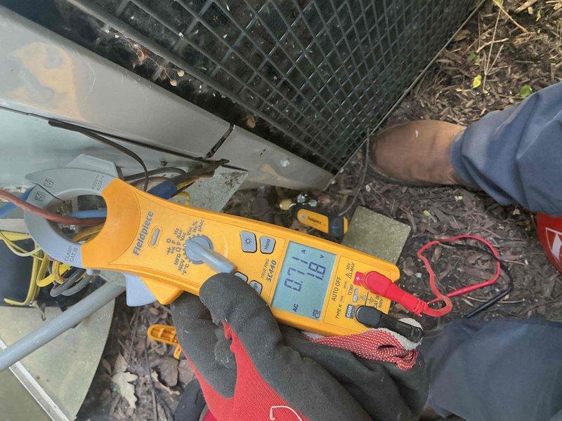 Completed comprehensive BFMA tune-up on 13+ year old outdoor air conditioning unit. Performed electrical diagnostics using clamp meter to verify amp draw and system performance, inspected capacitor and electrical connections, and assessed overall unit condition. Unit exhibited significant dirt accumulation on condenser coil and exterior grille, along with heavy organic debris buildup on top surface requiring attention for optimal airflow and efficiency.