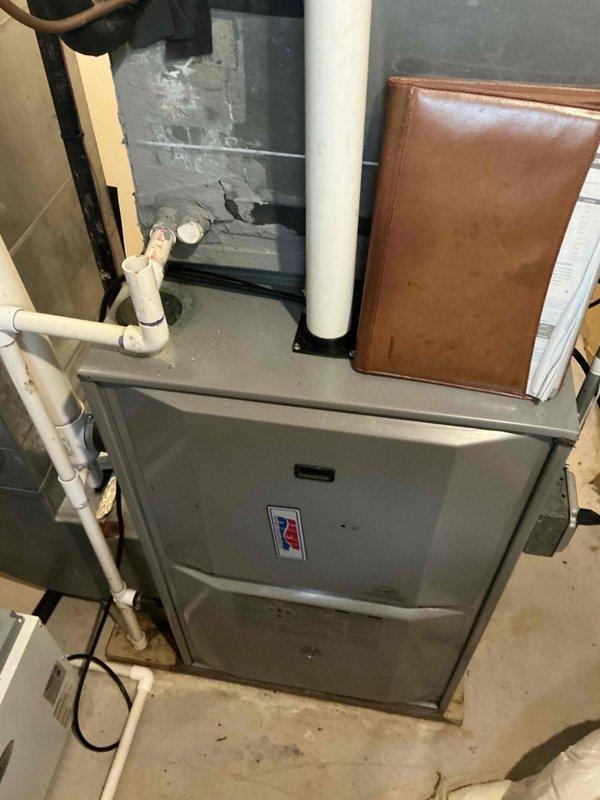 Responded to no-cooling complaint with AC line freezing and ice buildup on refrigerant lines. Performed diagnostic evaluation on 12-year-old system and identified low R22 refrigerant charge as primary cause of freeze-up condition. Completed comprehensive AC tune-up service including system inspection of furnace unit, electrical panel verification, and assessment of overall HVAC infrastructure in basement utility area. Provided estimate for A/C and coil replacement due to age of equipment and R22 refrigerant phase-out considerations. Discussed humidifier addition options for future membership inclusion.