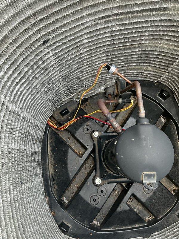Responded to call back following preventive maintenance to address leaves that were missed during initial cleaning. Removed debris from condenser base pan and verified unit was clear of obstructions. Inspected compressor assembly and refrigerant lines to ensure proper operation and cleanliness of all components within the condenser section.