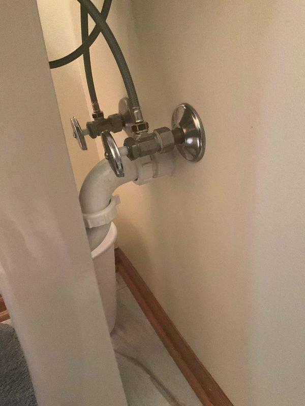 Completed comprehensive plumbing inspection of residential property. Evaluated kitchen sink plumbing fixtures and connections, confirming proper drainage and supply line integrity. Inspected washing machine water supply installation, including dual shut-off valves with cross-handle controls and braided stainless steel supply lines connected to wall-mounted chrome flanges. All plumbing components found to be in satisfactory working condition with no leaks or immediate concerns identified.