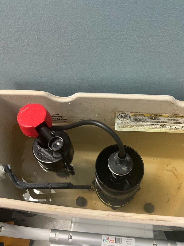 Removed and disposed of existing deteriorated flush gasket and fill valve from toilet tank. Installed client-provided flush gasket with no warranty on client-supplied parts, backed by 1-year labor warranty. Provided and installed new fill valve assembly with bright red adjustment cap, complete with 1-year parts and labor warranty. All components tested for proper operation and leak-free performance upon completion.