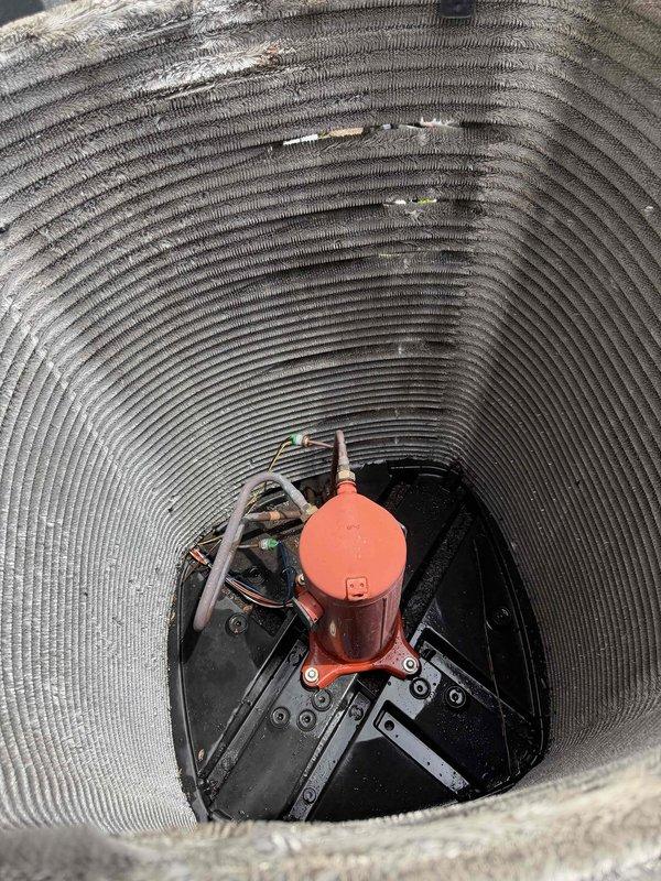 Completed comprehensive BFMA tune-up service on 15-year-old air conditioning system. Performed standard maintenance protocol including inspection of outdoor condensing unit, which exhibited heavy accumulation of dirt and debris on condenser coils requiring attention. Documented sump pump assembly condition in underground pit chamber, noting operational equipment with standing water present at base, and verified all electrical connections and wiring were secure and functioning properly.