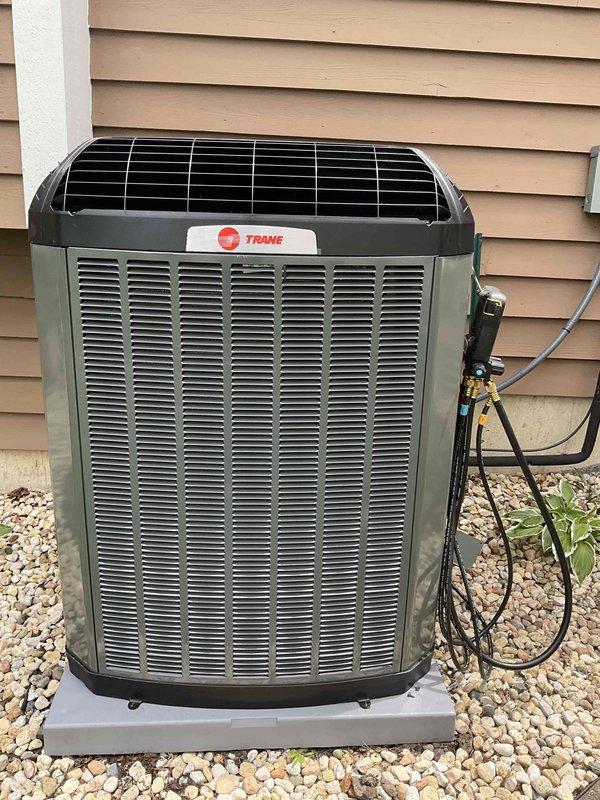Completed installation of new Trane 4-ton air conditioning system including 5TTX7048A1000 condenser unit and 5PXCC005AS evaporator coil with relay kit. Unit was set on concrete pad with proper gravel base, refrigerant lines and electrical connections were run to exterior disconnect box, system was charged and tested to manufacturer specifications, and new smart thermostat was installed and programmed for optimal operation.