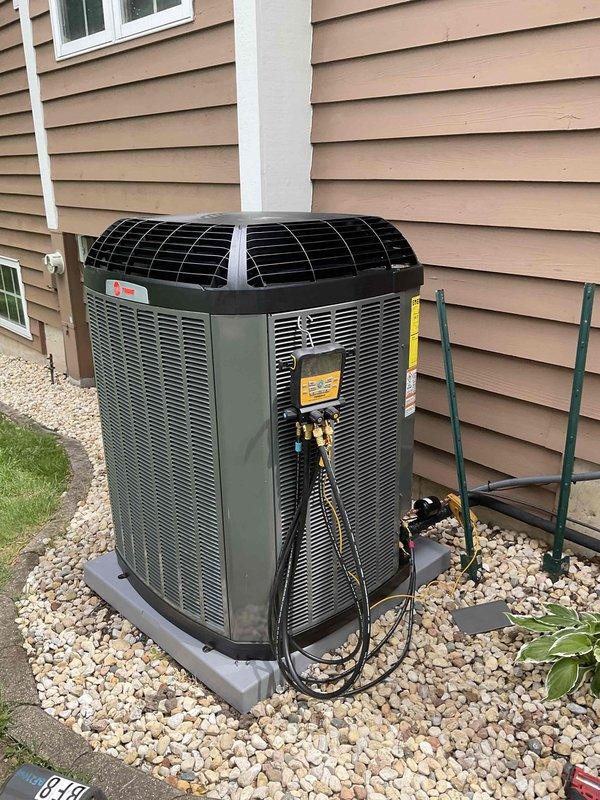 Completed installation of new Trane 4-ton air conditioning system including 5TTX7048A1000 condenser unit and 5PXCC005AS evaporator coil with relay kit. Unit was set on concrete pad with proper gravel base, refrigerant lines and electrical connections were run to exterior disconnect box, system was charged and tested to manufacturer specifications, and new smart thermostat was installed and programmed for optimal operation.