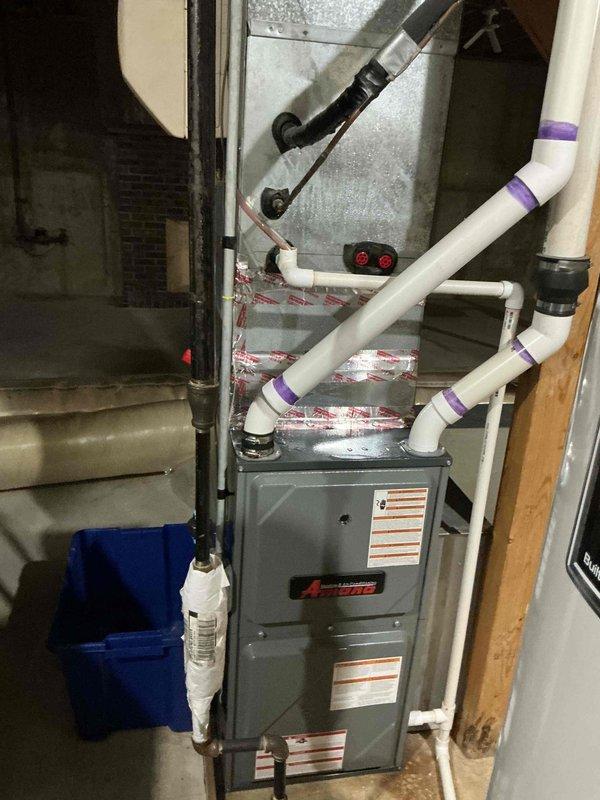Responded to no cooling complaint on residential HVAC system over 10 years old. Upon arrival, inspected both indoor furnace unit in basement mechanical room and outdoor condensing unit. Found outdoor unit with weathered refrigerant lines showing signs of age and exposure, positioned on concrete pad with deteriorating appearance. Indoor furnace and associated PVC condensate drainage system appeared functional. Documented existing equipment condition with photos showing aging infrastructure consistent with system age. Unit requires further diagnostic testing to determine root cause of cooling failure, likely related to refrigerant system or compressor issues given age of equipment.