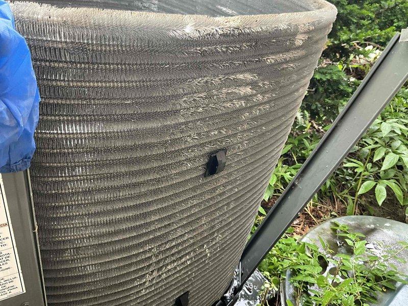 Completed comprehensive BFMA tune-up and AC inspection on 5-year-old system scheduled for afternoon arrival with 30-minute notice provided via text. Performed visual inspection of outdoor condenser unit, noting moderate dust and debris accumulation on horizontal fins of cylindrical coil assembly; inspected electrical connections at terminal block with multi-conductor wiring secured with cable ties showing proper termination and no signs of overheating or corrosion. All components found operational with normal wear patterns consistent with equipment age and outdoor exposure.