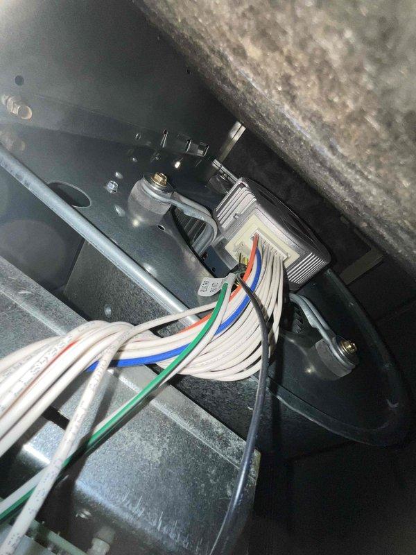 Completed comprehensive BFMA tune-up and AC inspection on 5-year-old system scheduled for afternoon arrival with 30-minute notice provided via text. Performed visual inspection of outdoor condenser unit, noting moderate dust and debris accumulation on horizontal fins of cylindrical coil assembly; inspected electrical connections at terminal block with multi-conductor wiring secured with cable ties showing proper termination and no signs of overheating or corrosion. All components found operational with normal wear patterns consistent with equipment age and outdoor exposure.