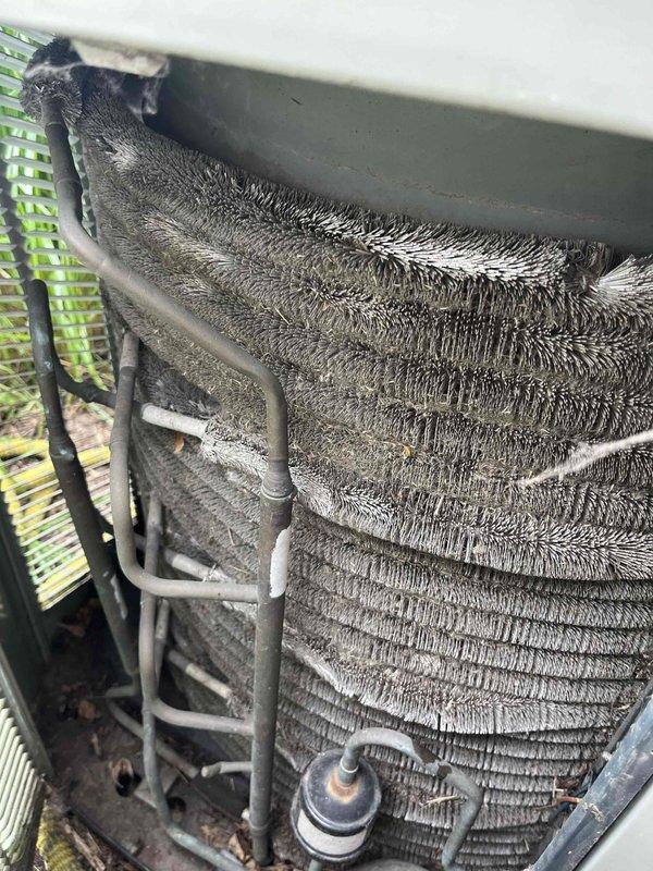 # HVAC Maintenance - BFMA Tune Up

Responded to scheduled afternoon appointment for comprehensive AC tune-up and preventive maintenance service on one-year-old system. Upon arrival and initial inspection, discovered evaporator coil completely covered in thick layer of frost and ice accumulation, indicating critical airflow restriction and potential refrigerant issues. Coil fins were barely visible beneath uniform frost buildup across entire assembly.

Further investigation revealed underlying cause: evaporator coil was heavily contaminated with significant dust, dirt, and debris accumulation. The buildup was so severe that individual coil fins were completely obscured, creating a thick matted layer that severely restricted airflow and system efficiency. This contamination directly contributed to the freezing condition observed.

Performed thorough system shutdown to allow ice accumulation to safely melt. Conducted comprehensive coil cleaning to remove all dust, lint, and debris from ev