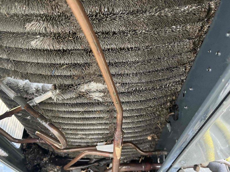 Completed comprehensive air conditioning tune-up on 7-year-old system, including inspection of evaporator coil which showed moderate dust and debris accumulation between fins, and exterior condenser unit evaluation. All components were inspected, cleaned where necessary, and system was verified to be operating within normal parameters.