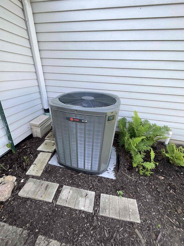 Completed comprehensive BFMA tune-up on 3-year-old residential air conditioning system. Upon arrival, discovered significant frost accumulation on condenser coil indicating potential refrigerant charge issue or restricted airflow. Inspected outdoor unit positioned on concrete pad with adequate clearance, noting debris and organic matter lodged between coil fins. Performed standard maintenance protocol including coil cleaning to remove accumulated dust, leaves, and debris from aluminum fins to restore proper heat exchange efficiency. Evaluated system operation, checked refrigerant levels, and addressed frost condition to ensure optimal cooling performance and prevent compressor damage.