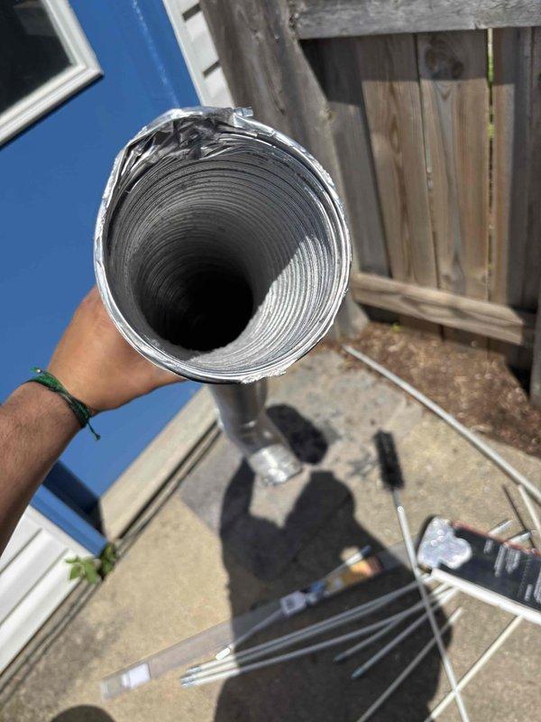 Completed comprehensive BFMA tune-up service on 7-year-old air conditioning system during scheduled morning appointment. Performed standard preventive maintenance protocol including system inspection, filter evaluation, and ductwork assessment. Documented flexible aluminum ductwork condition, noting interior dust accumulation along corrugated surfaces, and captured photographic evidence of duct interior showing typical debris buildup patterns consistent with system age and usage.