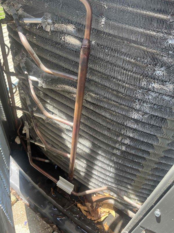 Completed comprehensive BFMA tune-up service on 3-year-old Trane air conditioning system. Performed standard preventive maintenance procedures including inspection of condenser unit, coil cleaning, refrigerant line assessment, and system operational verification. Unit found in satisfactory operating condition with copper lines showing normal oxidation; removed debris accumulation from base of outdoor unit and confirmed proper airflow through fin assembly.