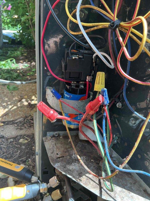 Responded to callback for A/C unit shutting off intermittently during operation. Upon arrival, accessed outdoor condensing unit electrical panel and performed diagnostic testing. Measured compressor amperage at 63.17 amps using clamp meter to verify electrical performance. Inspected control board connections, capacitor, and all wire terminations within the electrical compartment. Found and addressed wiring concerns related to previous service visit. Verified proper wire connections at contactor and capacitor terminals, securing all connections with appropriate wire nuts. Cleaned debris from electrical panel base. System tested and operating normally at time of departure.