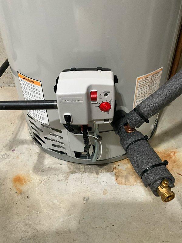 Responded to no hot water complaint following previous day's AC installation. Upon arrival, inspected tanked water heater unit with ICON System control module. Found power switch in OFF position at base of unit. Restored power to water heater by switching ON/OFF rocker switch to ON position and verified temperature dial was set to appropriate heating level on STATUS control. Confirmed all supply line connections, brass fittings, and foam-insulated pipes were secure with no visible leaks. Tested unit operation and verified pilot light ignition. Water heater restored to full functionality with hot water production confirmed before departure.