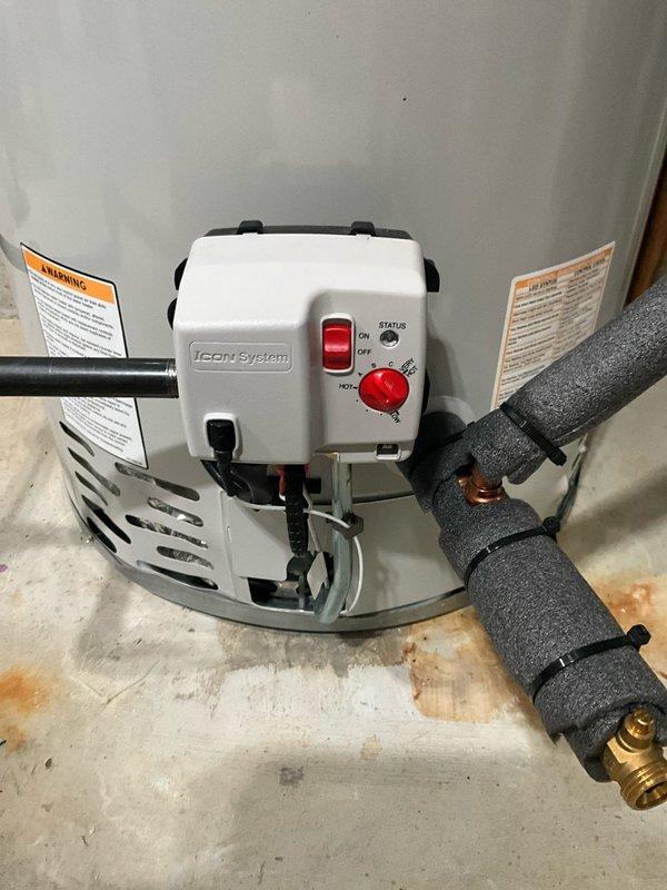Responded to no hot water complaint following previous day's AC installation. Upon arrival, inspected tanked water heater unit with ICON System control module. Found power switch in OFF position at base of unit. Restored power to water heater by switching ON/OFF rocker switch to ON position and verified temperature dial was set to appropriate heating level on STATUS control. Confirmed all supply line connections, brass fittings, and foam-insulated pipes were secure with no visible leaks. Tested unit operation and verified pilot light ignition. Water heater restored to full functionality with hot water production confirmed before departure.