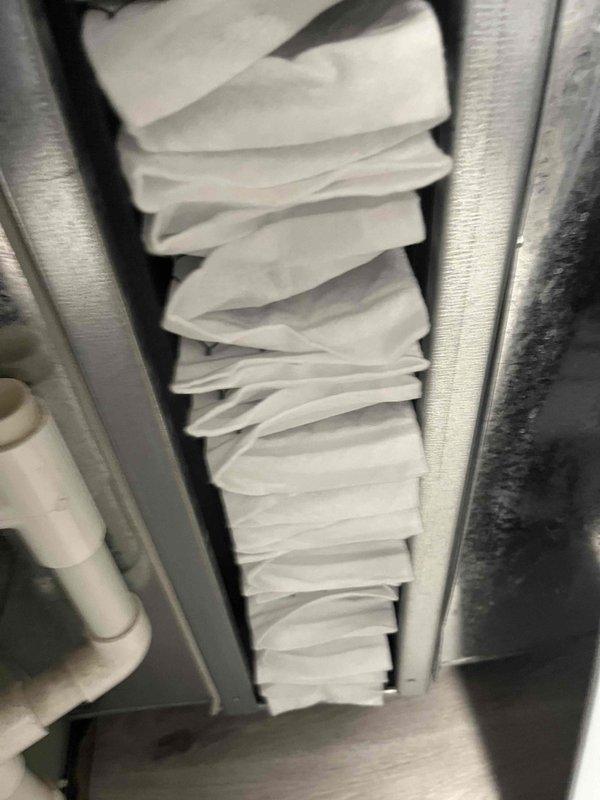 Completed comprehensive BFMA tune-up service on a 9+ year old air conditioning system, including full system inspection and air cleaner filter replacement. Inspected evaporator coil assembly and verified proper refrigerant line connections, noting normal operational wear consistent with equipment age. Installed new pleated air filter in metal frame housing and confirmed all components functioning within manufacturer specifications.