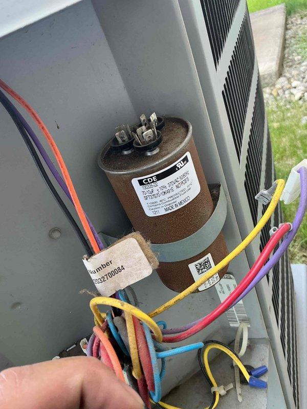 Replaced failed condenser fan motor in commercial Ducane condensing unit. Disconnected electrical connections, removed old motor from housing, installed new motor assembly, reconnected wiring to dual-run capacitor and terminal block, and verified proper operation. Unit restored to full cooling capacity.