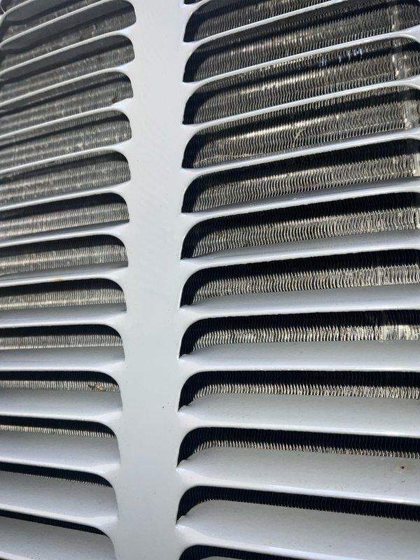 Completed comprehensive BFMA tune-up service on a 4-year-old Amana air conditioning system. Performed full inspection of outdoor condenser unit, cleaned evaporator and condenser coils, verified proper airflow through heat exchanger fins, and documented system condition with photographic evidence. Unit operating within normal parameters with no issues identified.