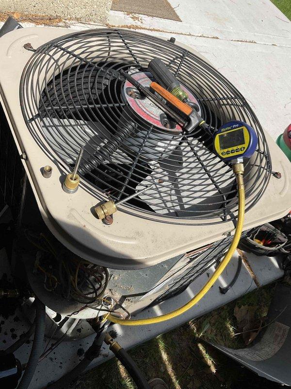 Reinstalled air conditioning condenser unit that was previously disconnected for patio construction. Connected refrigerant lines, performed system pressure testing using manifold gauges and digital diagnostic equipment, and verified proper operation. Unit showed significant dirt accumulation on intake filter from storage period, which will require cleaning or replacement during next scheduled maintenance visit.
