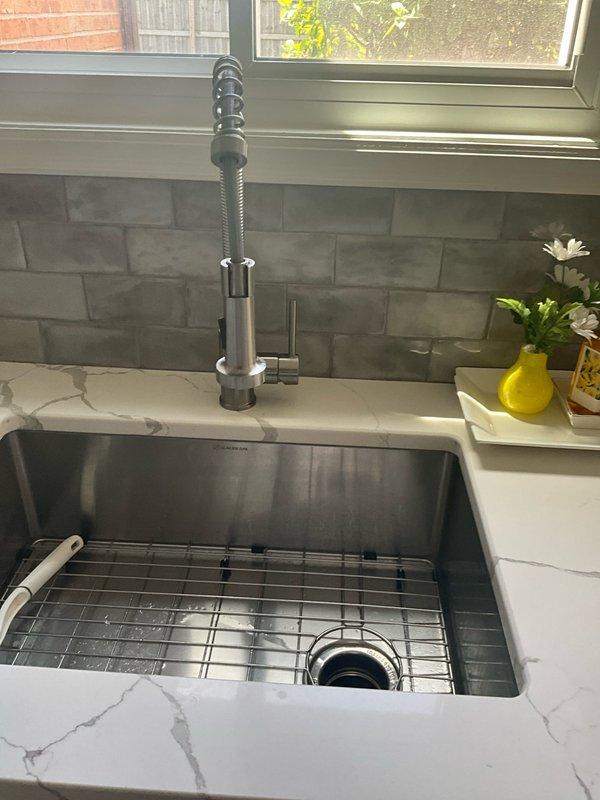 Responded to service call for leaking garbage disposal unit. Upon inspection, identified leak at discharge connection point where disposal unit connects to drain line. Removed and cleaned existing connection, replaced worn gasket and discharge elbow fitting, and reinstalled with proper sealant. Tested disposal operation and verified all connections are secure with no active leaks present.